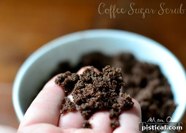 Four small jars filled with homemade DIY Coffee Sugar Scrub, elegantly presented for gifting or personal use.