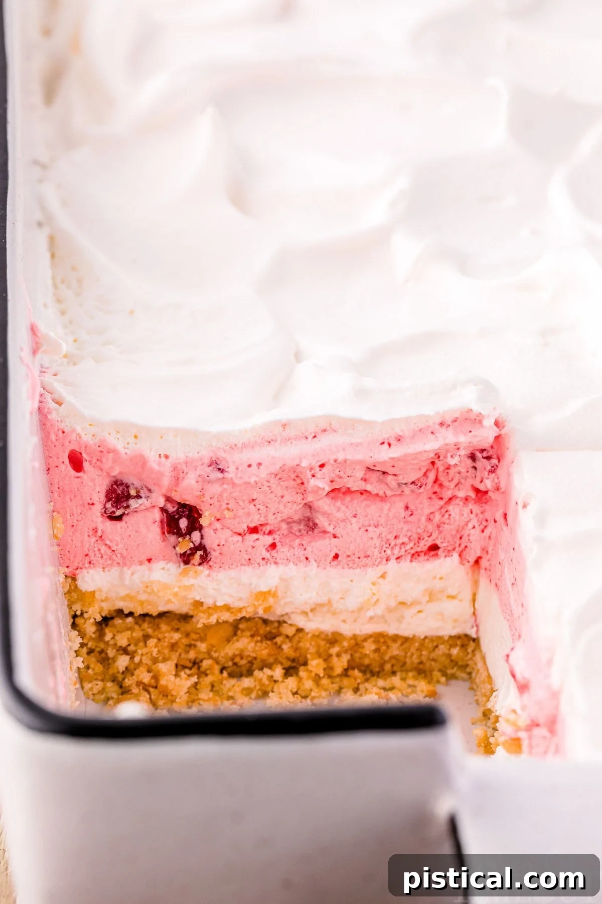 Layered Strawberry Dream 3 Strawberry lasagna with a slice taken out of it.