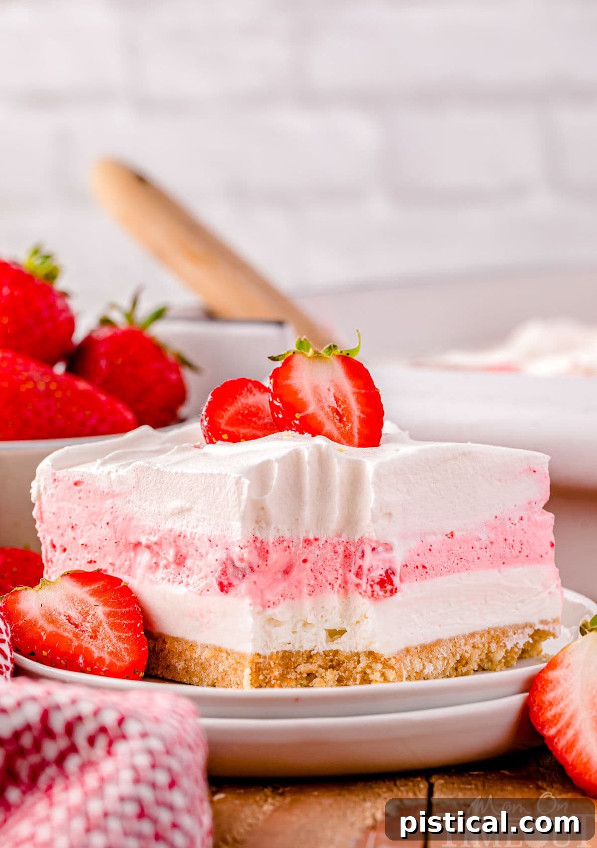 Layered Strawberry Dream 8 A slice of strawberry lasagna on a white plate.