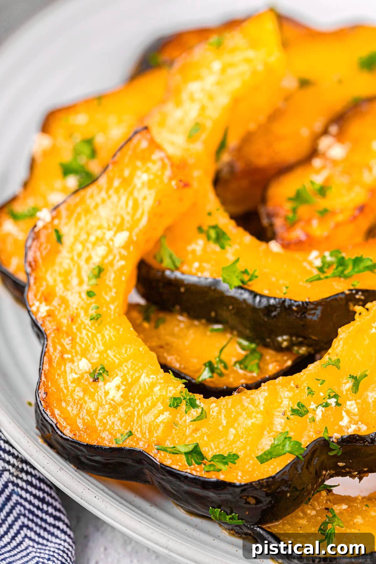 Close up of slices of roasted acorn squash, perfectly caramelized and ready to serve.