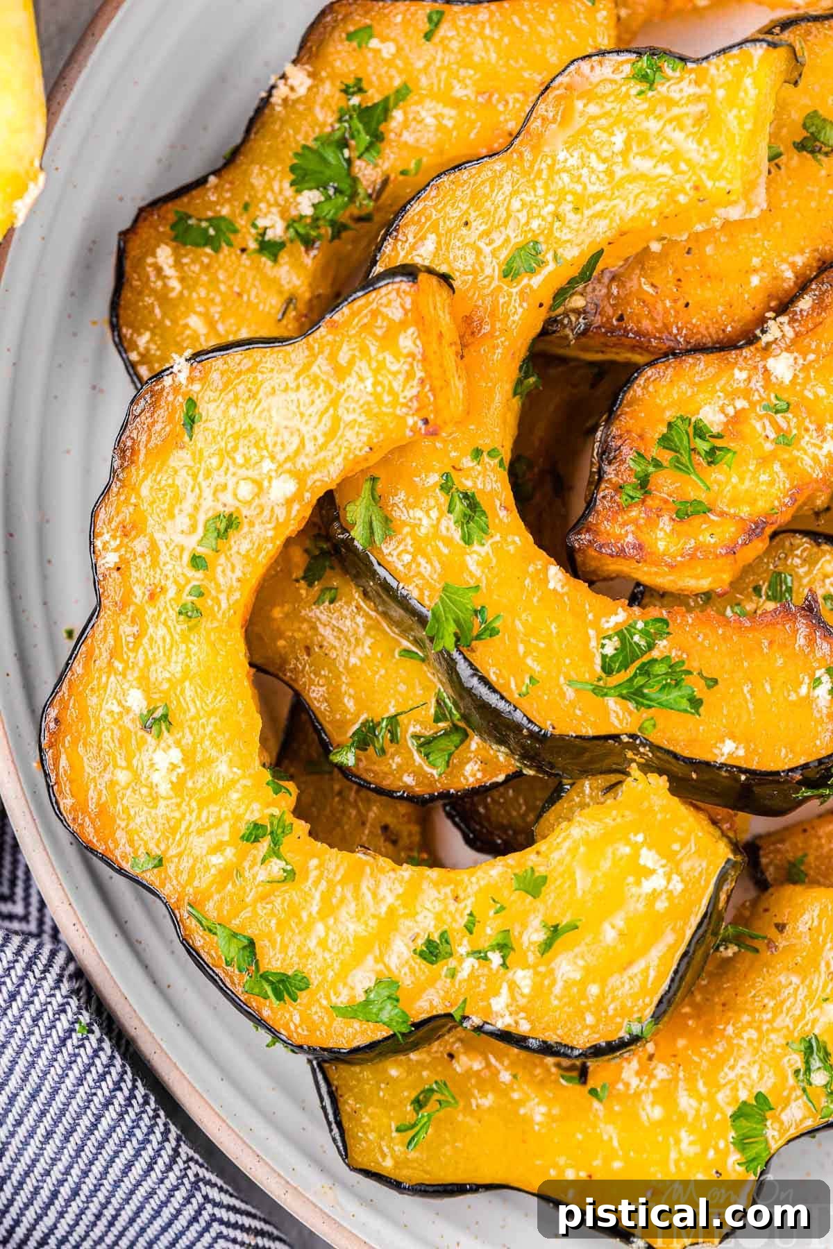 Top down shot of several slices of roasted acorn squash on a white background, showing their beautiful texture.