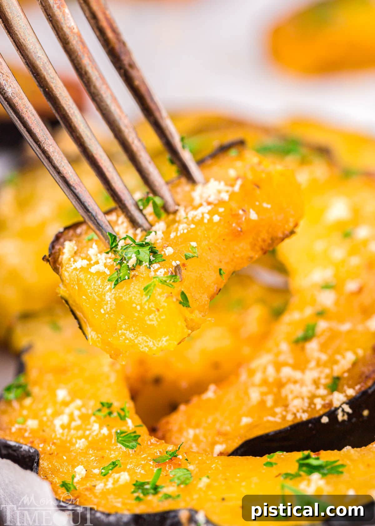 A fork piercing a tender piece of roasted acorn squash, highlighting its soft texture.