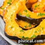 Close up of slices of acorn squash on a plate.
