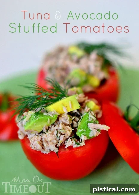 Tuna and Avocado Stuffed Tomatoes: a healthy, light lunch option filled with nutrient-rich tuna and creamy avocado salad in a fresh tomato.