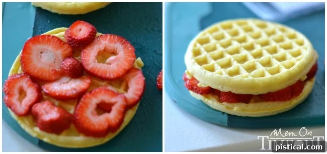 Layering waffles with fresh strawberry slices for a delicious filling