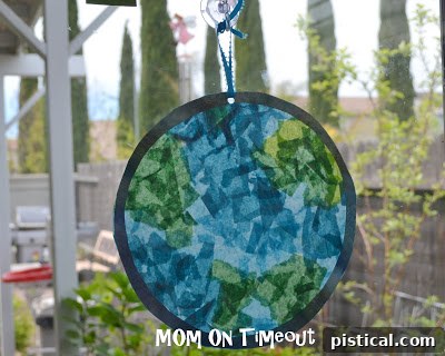 Finished Stained Glass Earth craft displayed in a window, catching sunlight
