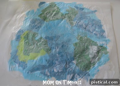 Wax paper folded over tissue paper, smoothed out to seal the design