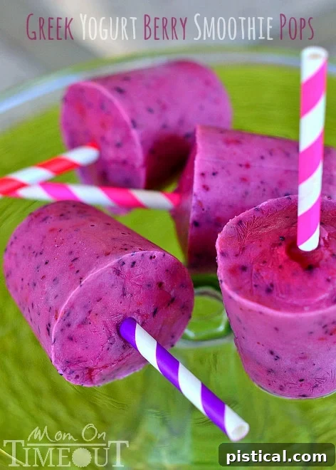 Refreshing Greek Yogurt Berry Smoothie Pops in a glass, perfect for summer. Easy to make, healthy, and kid-friendly frozen treat.