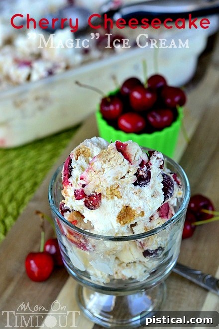 A bowl of finished Cherry Cheesecake Magic Ice Cream, ready to be frozen. The vibrant red cherries and brown graham cracker pieces are visible within the creamy white ice cream base.