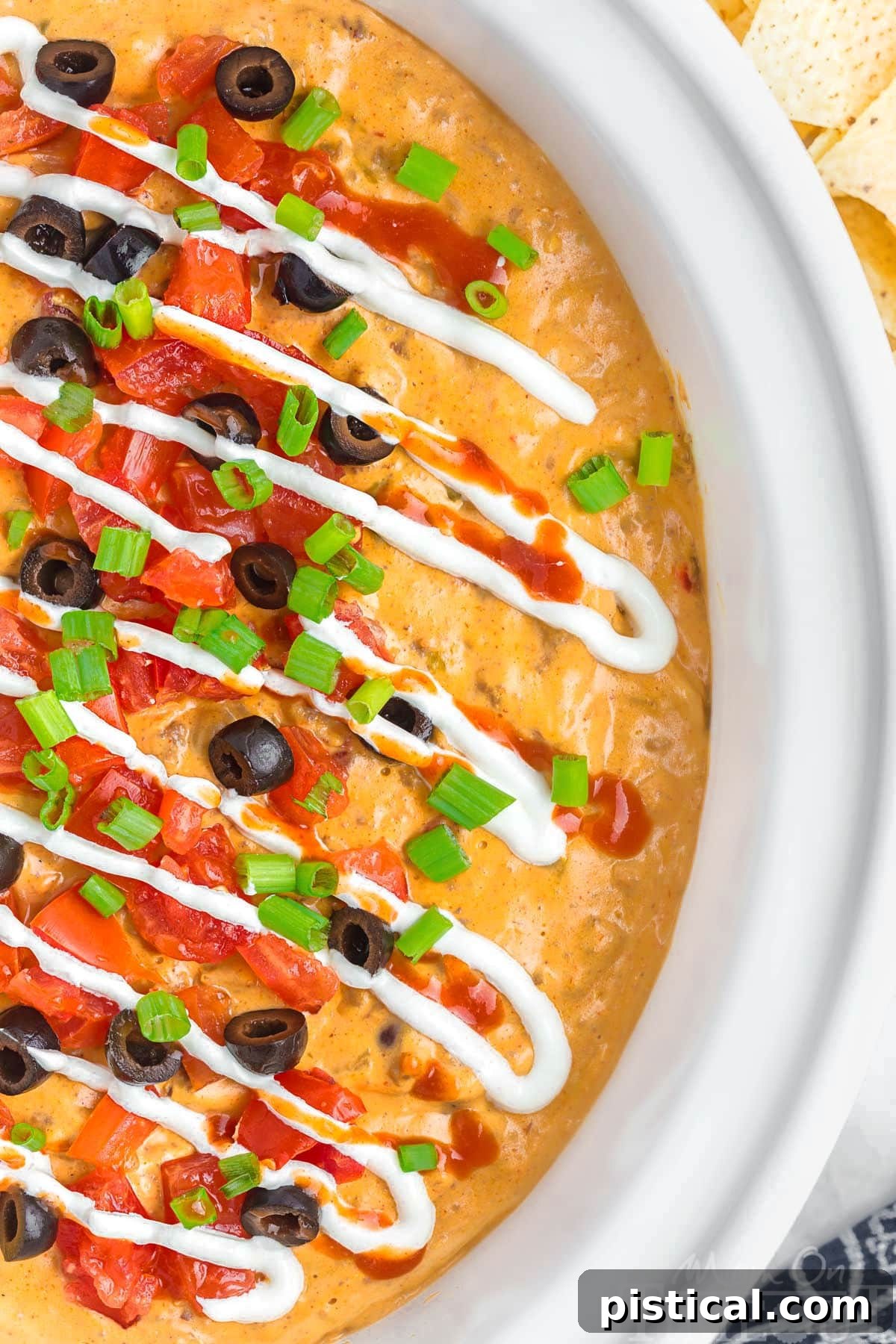 Warm & Cheesy Slow Cooker Taco Dip 2 Top down view of crockpot taco dip in a white crockpot insert.