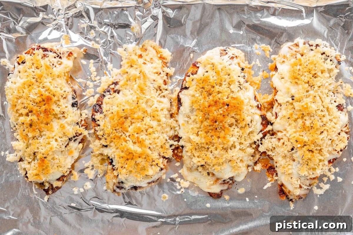 Steakhouse-Style Parmesan Crusted Chicken 3 Longhorn Steakhouse Parmesan Crusted Chicken on foil lined pan.