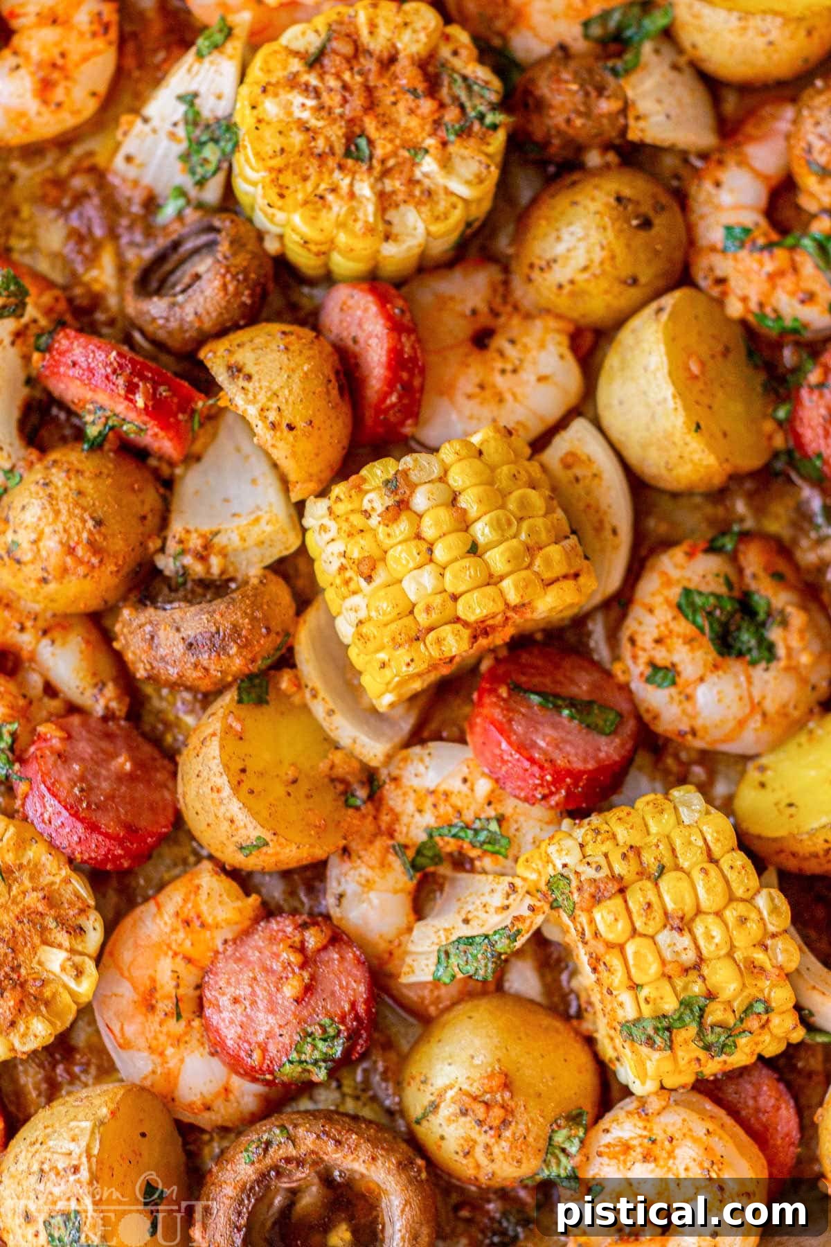Top down view of sheet pan low country shrimp boil topped with parsley.