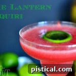 Lime Lantern Daiquiri cocktail in martini glasses with flaming lime garnish