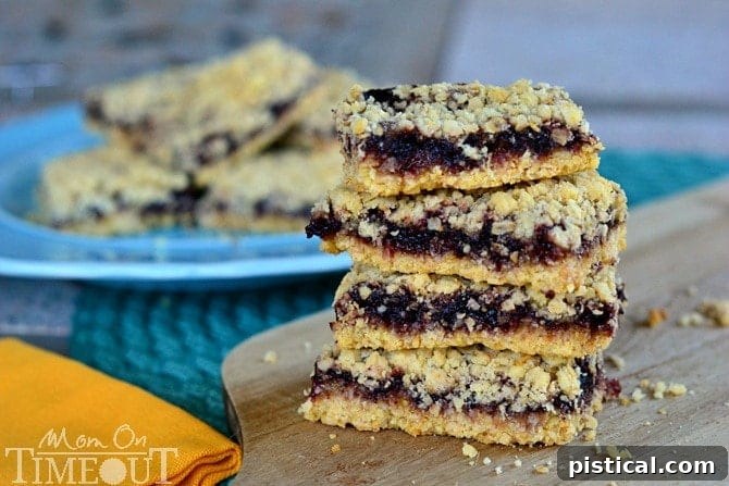 Close-up of golden-brown Blackberry Oatmeal Crumble Bars in a baking dish, highlighting the texture and fruit filling, a perfect simple dessert.