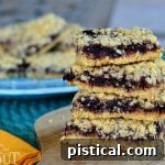 A square image of a baked Blackberry Oatmeal Crumble Bar, inviting and delicious.