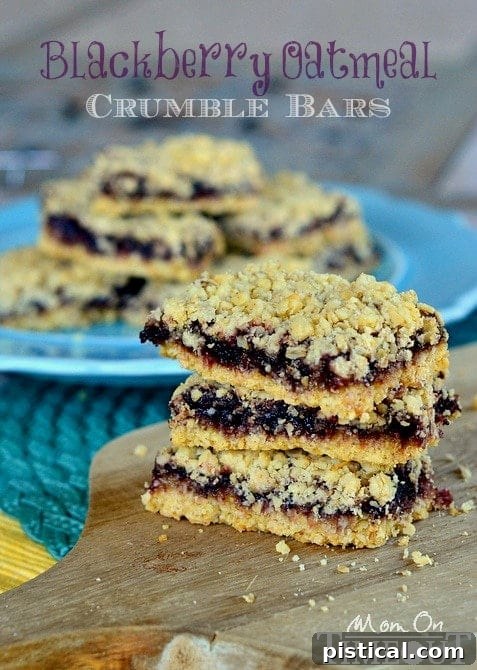 A stack of beautifully baked Blackberry Oatmeal Crumble Bars, ready to be enjoyed as a sweet treat.