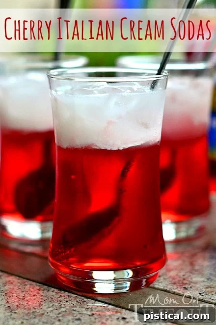 Easy Cherry Italian Cream Soda Recipe Homemade Cherry Italian Cream Soda in a tall glass, vibrant red with a creamy top layer.