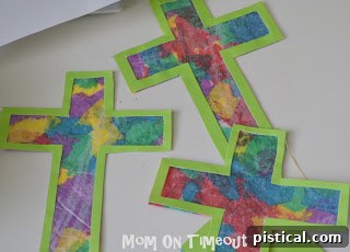 Completed stained glass crosses being cut out from the wax paper, ready for display.