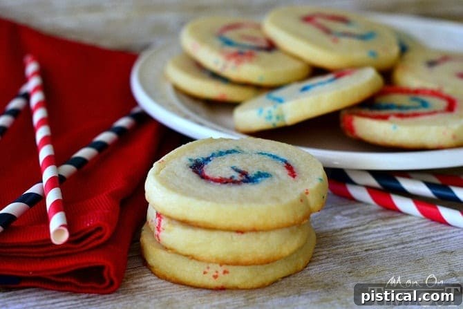 Arrangement of Red, White, and Blue Sparkler Cookies on a rustic wooden surface, showcasing their vibrant colors.