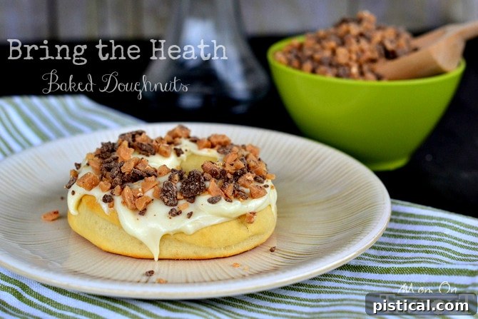 Close-up photo of a baked Heath doughnut being generously frosted with smooth cream cheese icing.
