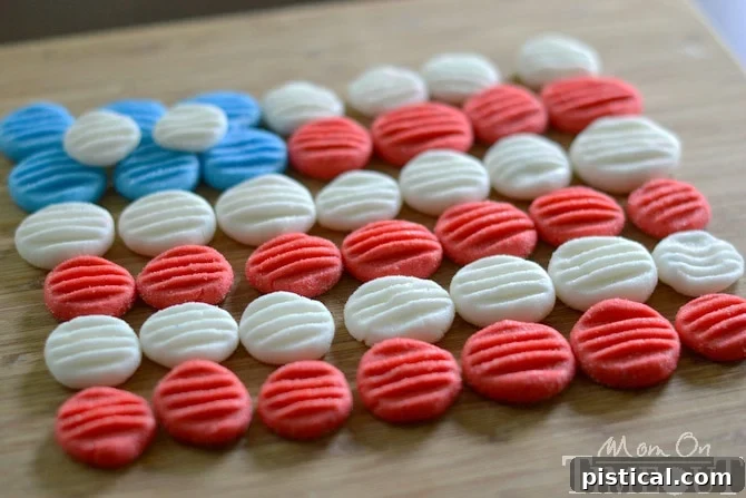 Vibrant Red, White, and Blue Peppermint Patties: Perfect for Any Celebration! An assortment of red, white, and blue homemade peppermint patties, some flattened with a fork for texture, displayed on a serving tray.