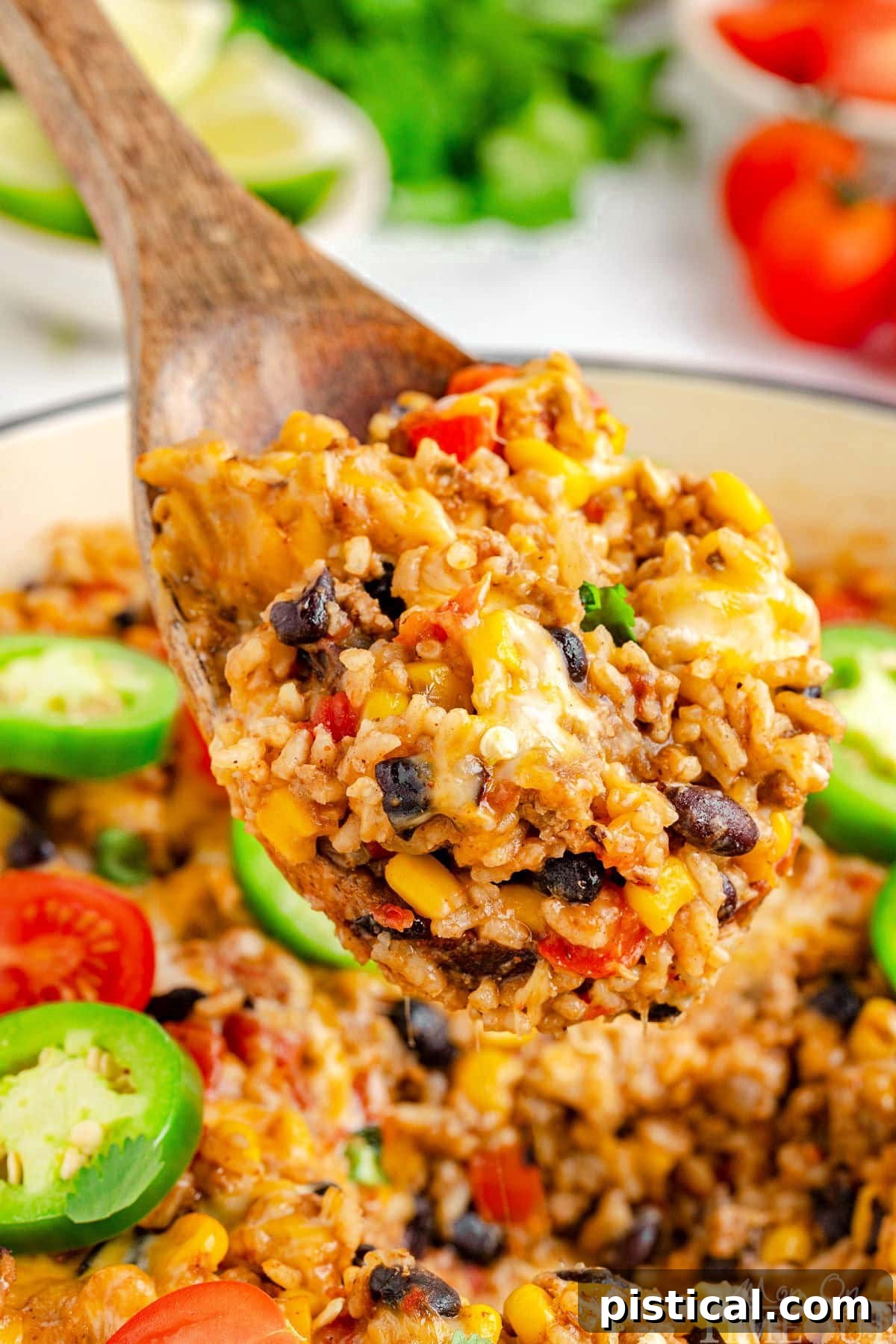 Ultimate Cheesy Taco Rice Skillet 5 A wooden spoon delicately scooping a generous serving of Cheesy Taco Rice from a rustic white skillet, showcasing the perfectly cooked rice, melted cheese, and colorful ingredients within.