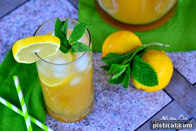 Practically Perfect Pineapple Punch served over ice with garnishes.