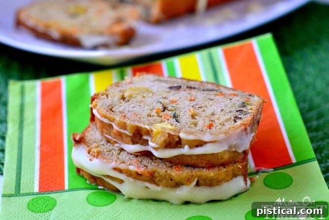 Cross-section of Carrot Zucchini Apple Bread, showing its moist crumb, vibrant colors from carrots and zucchini, and soft apple pieces.