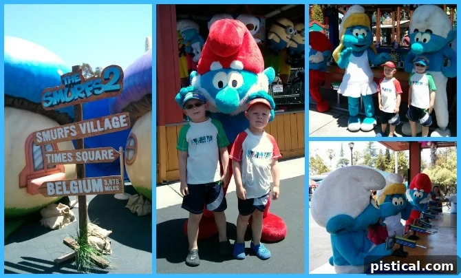 Children posing with Smurfs characters in Smurfs Village.