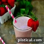 Close-up of a perfectly blended Strawberry Malted Milkshake in a glass