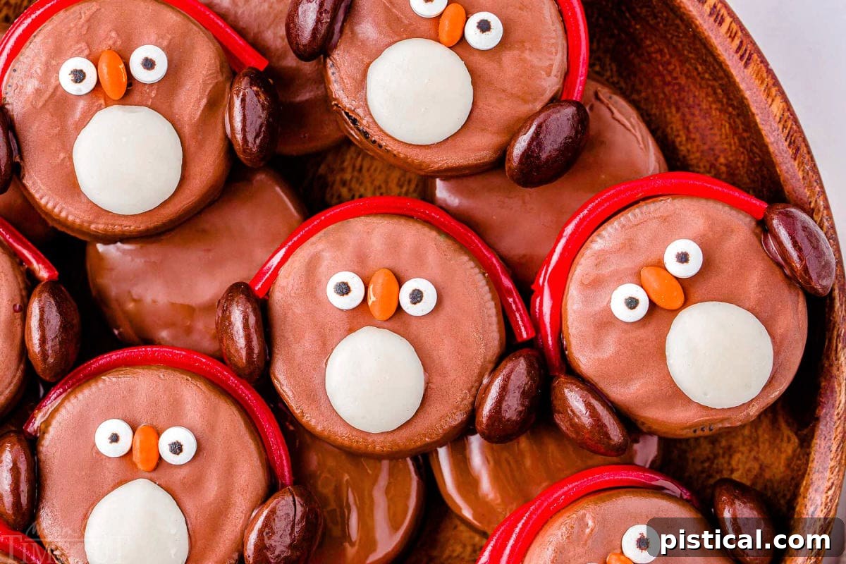 Top down look at a dozen penguins made with oreo cookies on a wood tray.