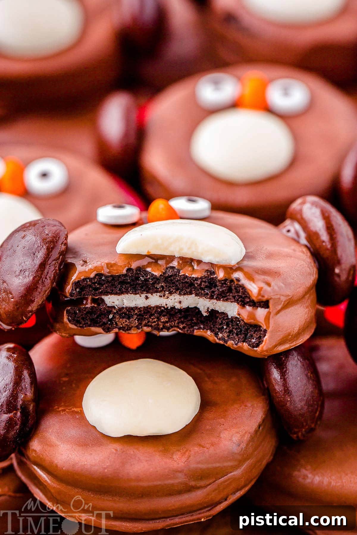 Shot of Oreo Penguin bitten in half so you can see the Oreo center. The cookie is sitting on more oreo penguins.