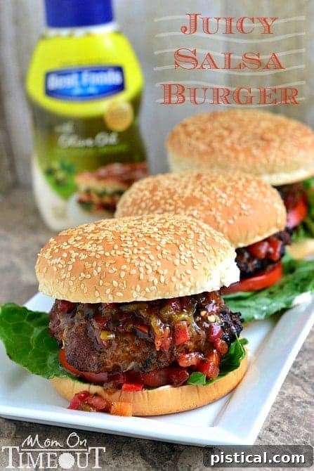 Three grilled Juicy Salsa Burgers on buns with fresh salsa, ready to be served