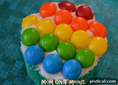 Another view of the rainbow cupcakes, emphasizing the fun and festive nature of the dessert
