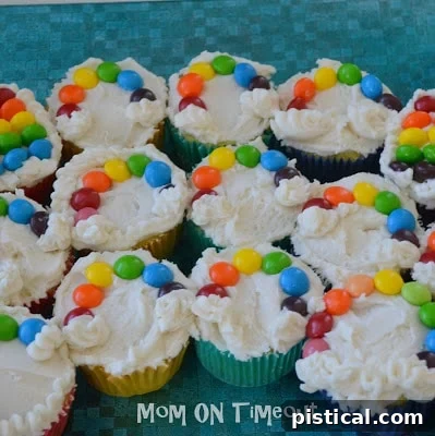 Multiple finished rainbow cupcakes arranged together, displaying a delightful array of colors