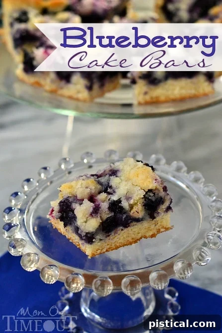 Delicious Blueberry Cake Bars from MomOnTimeout.com, a perfect sweet treat for any time of day. Features fresh blueberries and a moist cake texture.