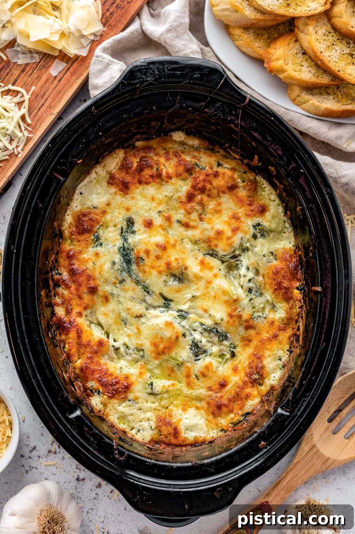 Top down view of spinach artichoke dip in crockpot.