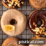 Shot of banana donuts topped with glazes and cinnamon sugar.