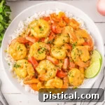 Overhead shot of coconut shrimp bowl served with rice in round white bowl.