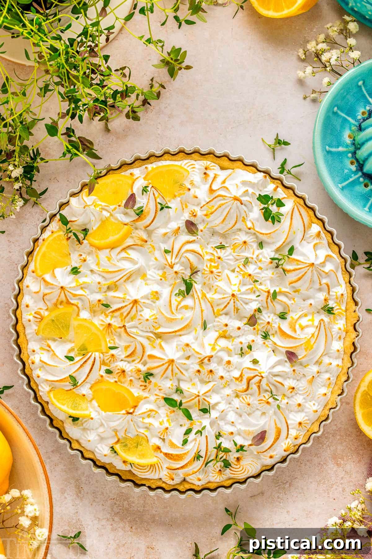 Zesty Lemon Cloud Tart 3 A stunning top-down view of a whole Lemon Meringue Tart, artfully garnished with fresh lemon wedges and delicate sprigs of lemon thyme.