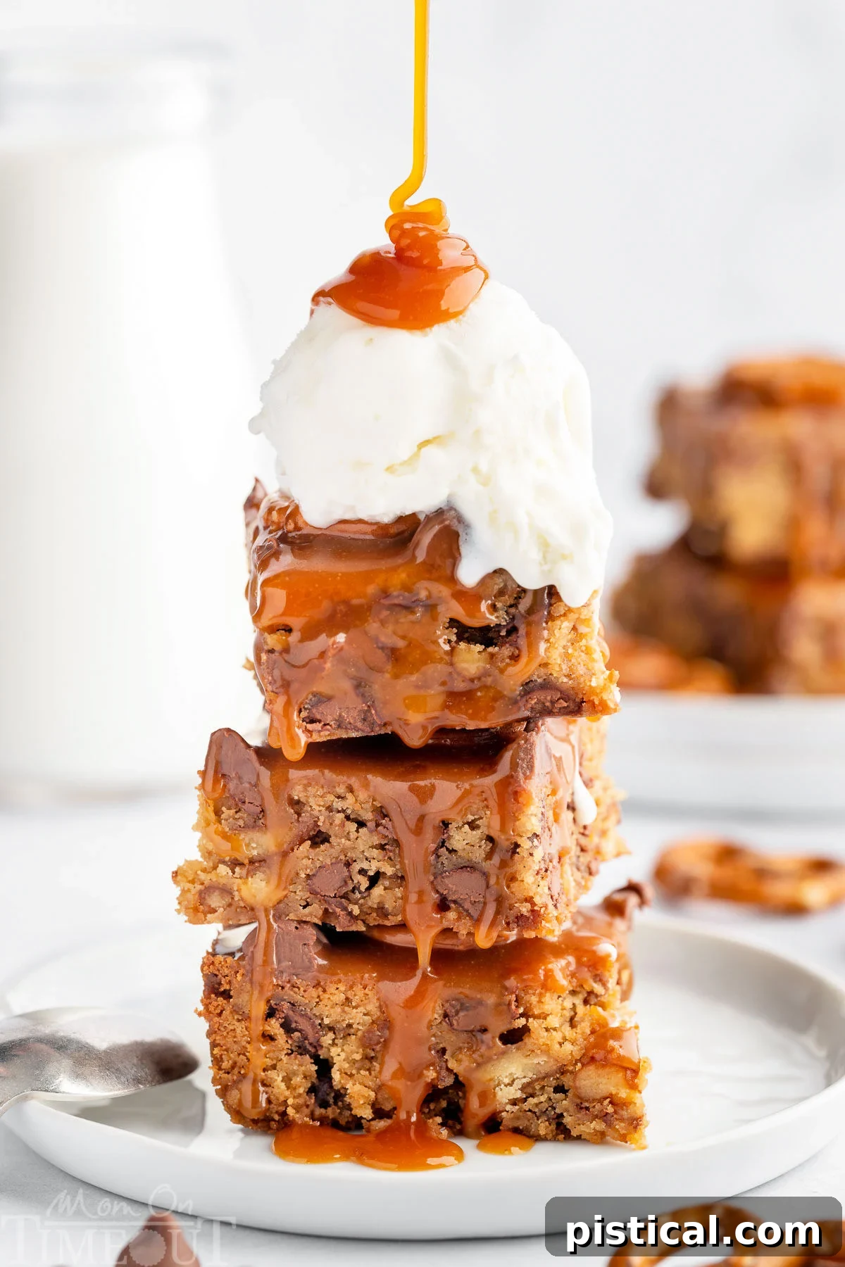 Sweet Salty Blondie Squares 6 A stack of blondies with a scoop of vanilla ice cream and salted caramel sauce drizzled on top.