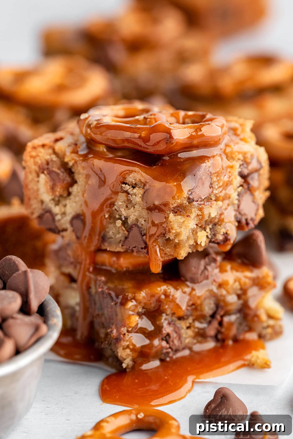 Sweet Salty Blondie Squares 7 Salted Caramel Blondies in a stack with a drizzle of salted caramel on top.