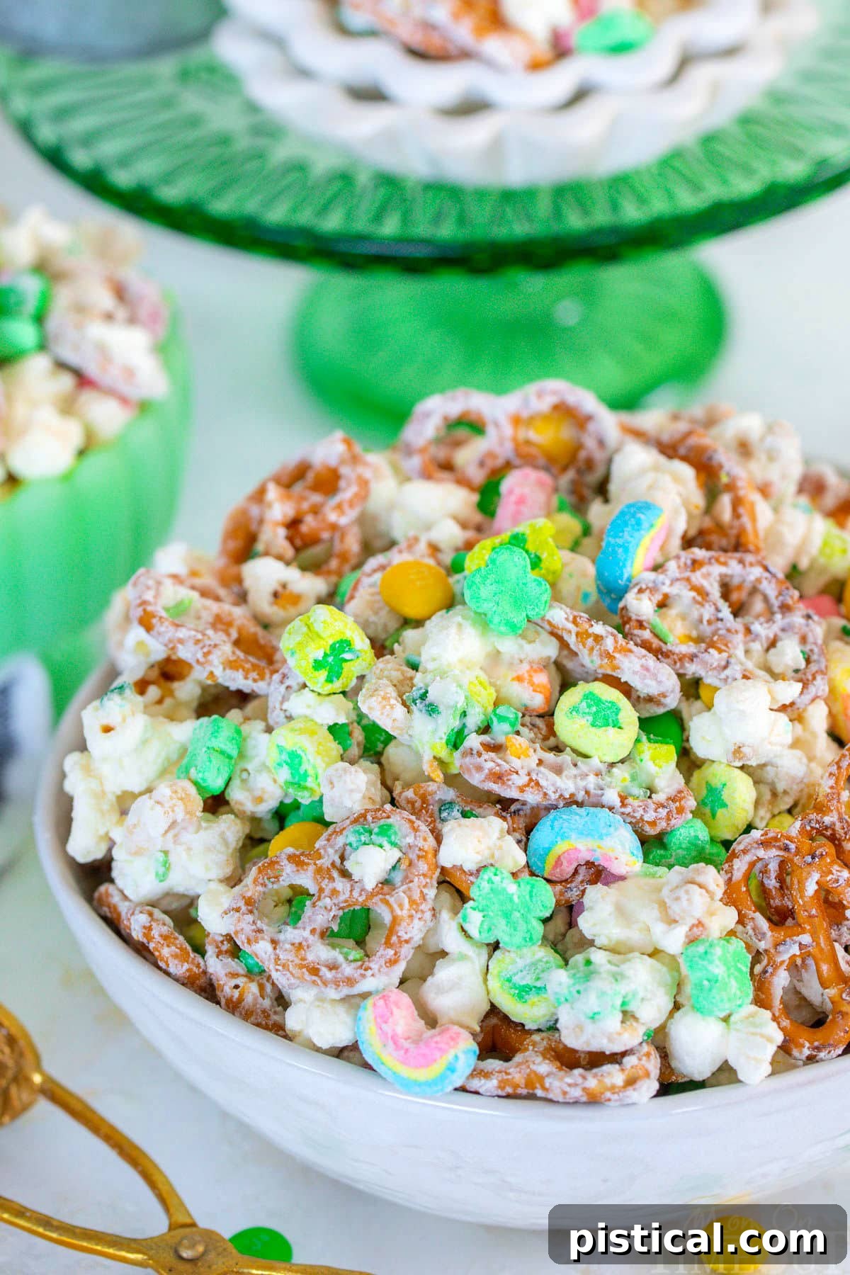 Close up look at Leprechaun Bait in white bowl with green cake stand in background.