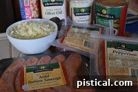 Ingredients for a meat lover's stuffed crust pizza including sausage, pepperoni, salami, and cheese.