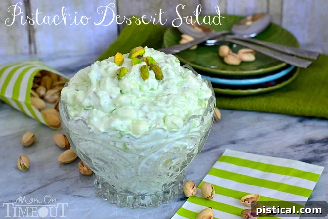 Close-up of fluffy pistachio dessert salad, showing marshmallows and nuts, ready to be served.