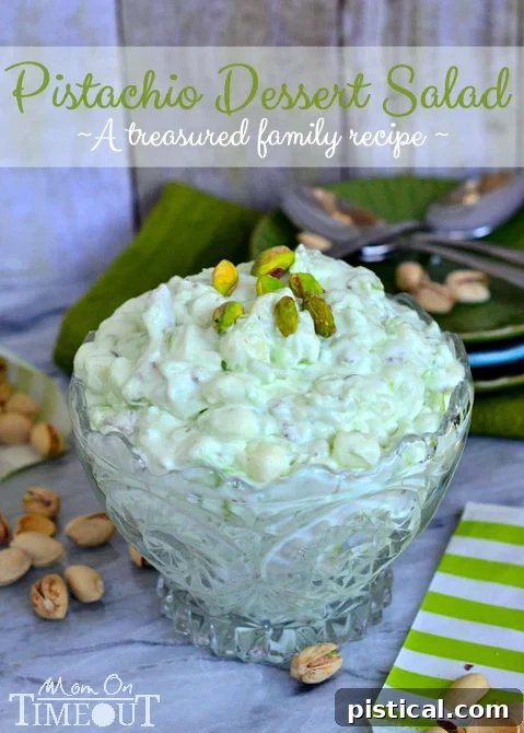 A serving of pistachio dessert salad, highlighting its creamy texture and the mix of colorful ingredients.