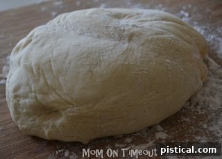 Finished pizza dough removed from the bread machine and placed on a floured surface. Ready for shaping.
