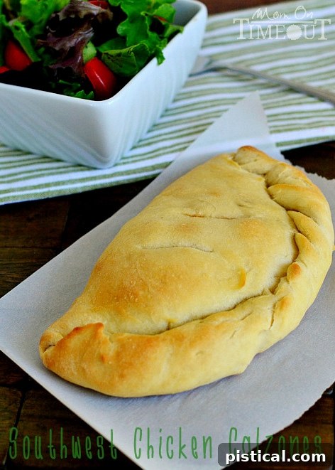 A close-up shot of a perfectly baked Southwest Chicken Calzone, showcasing its inviting golden-brown crust and hinting at the savory filling inside. An ideal choice for a quick, delicious, and satisfying family dinner. Find this easy recipe and many more culinary inspirations at MomOnTimeout.com. Remember to actively #ClipForSchool with Tyson Project A+ to support your local educational institutions!
