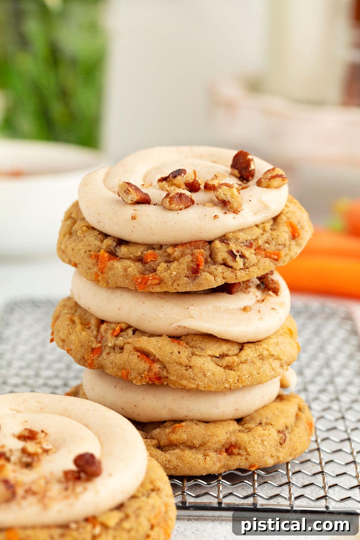 Cream Cheese Frosted Carrot Cookies 3 Freshly baked Carrot Cake Cookies neatly stacked on a cooling rack, ready for frosting.