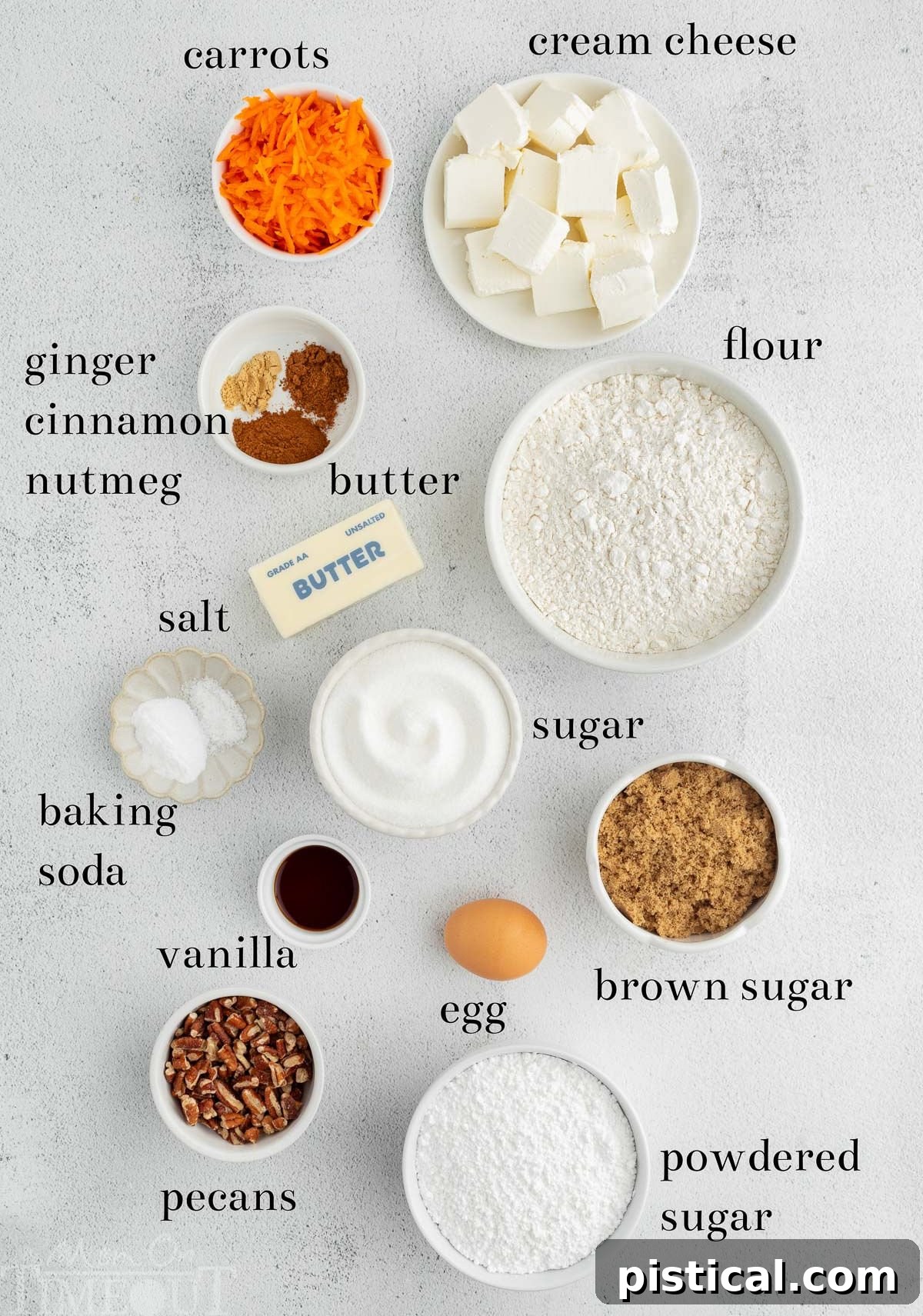 Cream Cheese Frosted Carrot Cookies 4 A meticulously arranged display of all the essential ingredients for baking Carrot Cake Cookies, clearly labeled on a pristine light-colored surface.